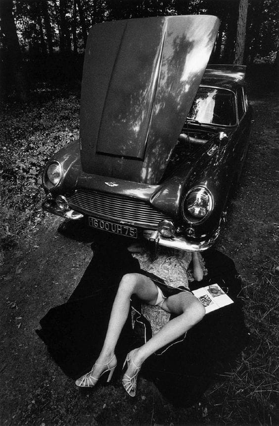 Girl Mechanic Fixing Jaguar Under Car