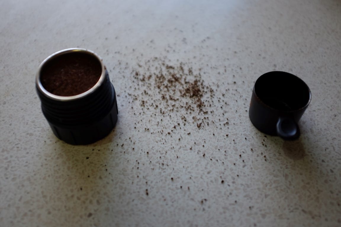 Putting coffee into portable espresso maker